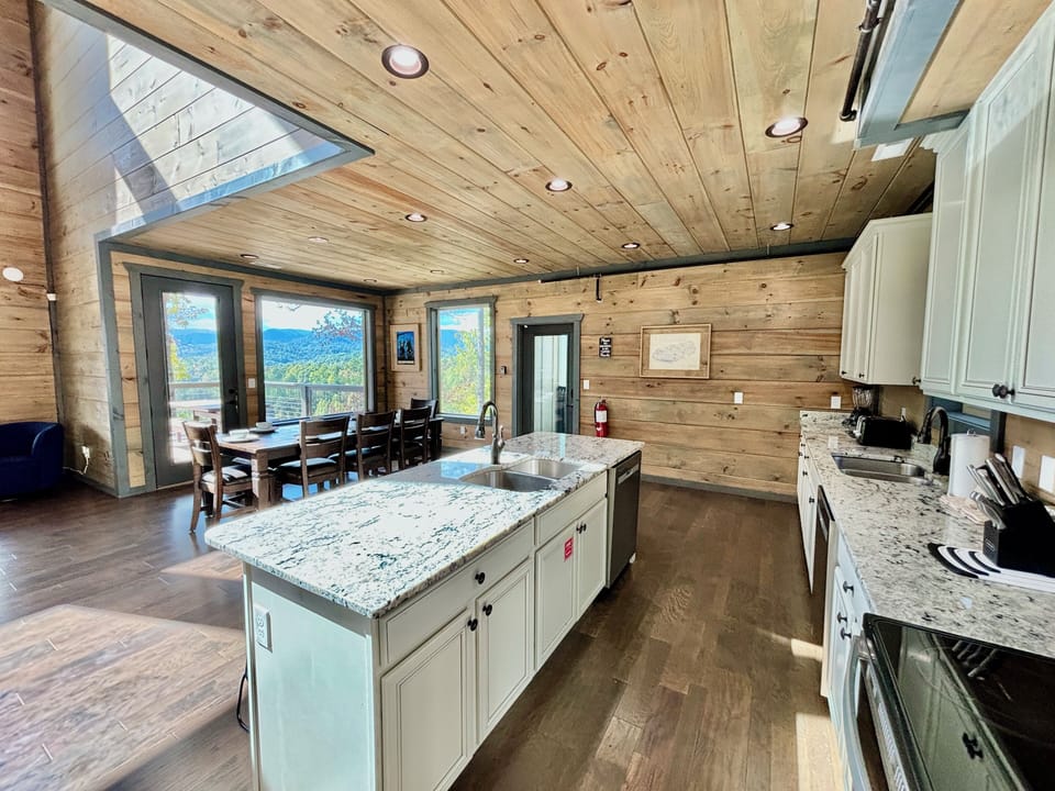 Cook in a rustic-modern kitchen with granite countertops, wood accents