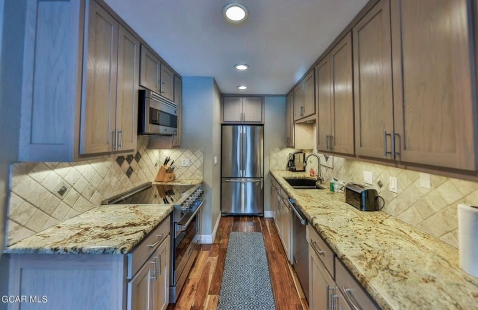 Cooking kitchen with Viking appliances and well stocked cupboards