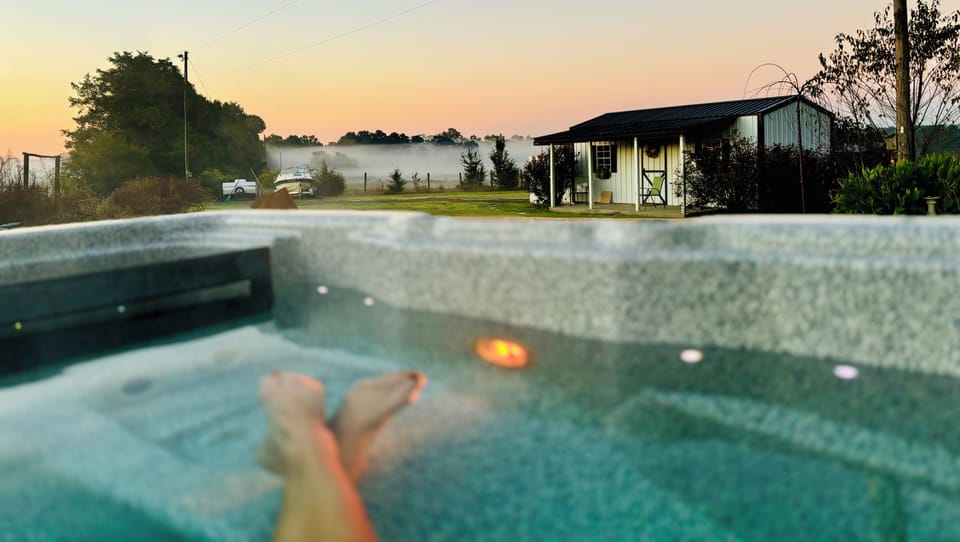 Relax in the secluded back patio hot tub, overlooking farmland horses & cows