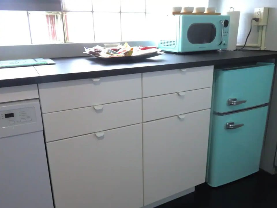 Kitchen filled with drinks and snacks. 