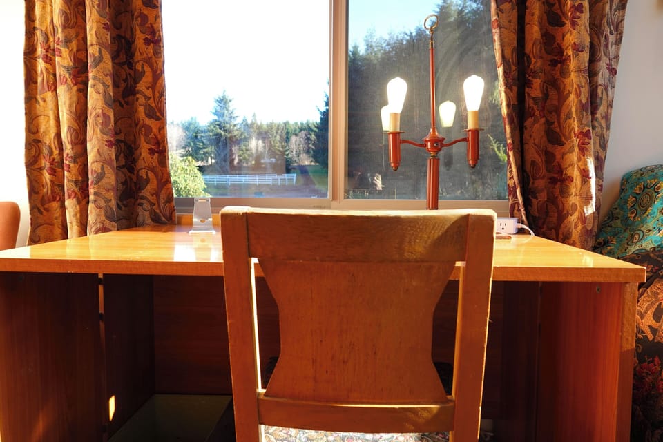Bedroom 1 has a dedicated desk and view of the lane and fields