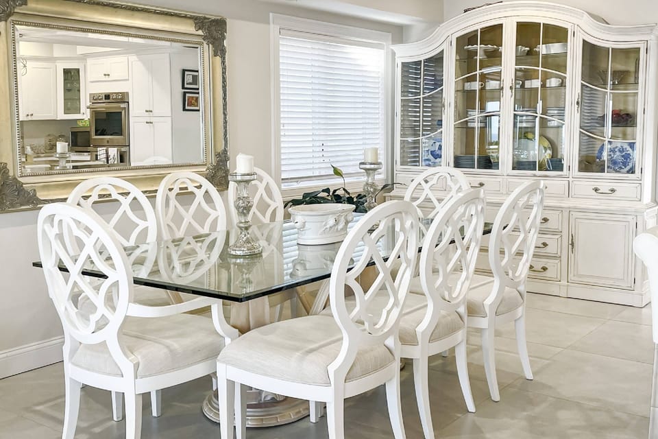 Gather around the sleek glass table — seating for eight makes every meal a celebration by the water.