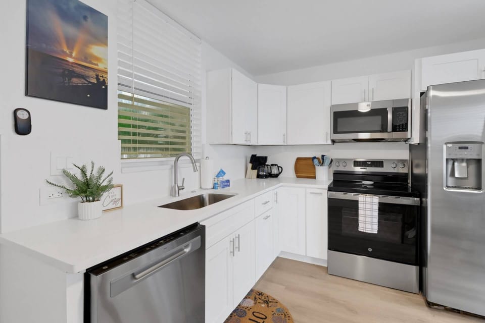 Cookware, dinnerware, many kitchen tools and small appliances are provided, including a drip coffee maker and electric kettle.