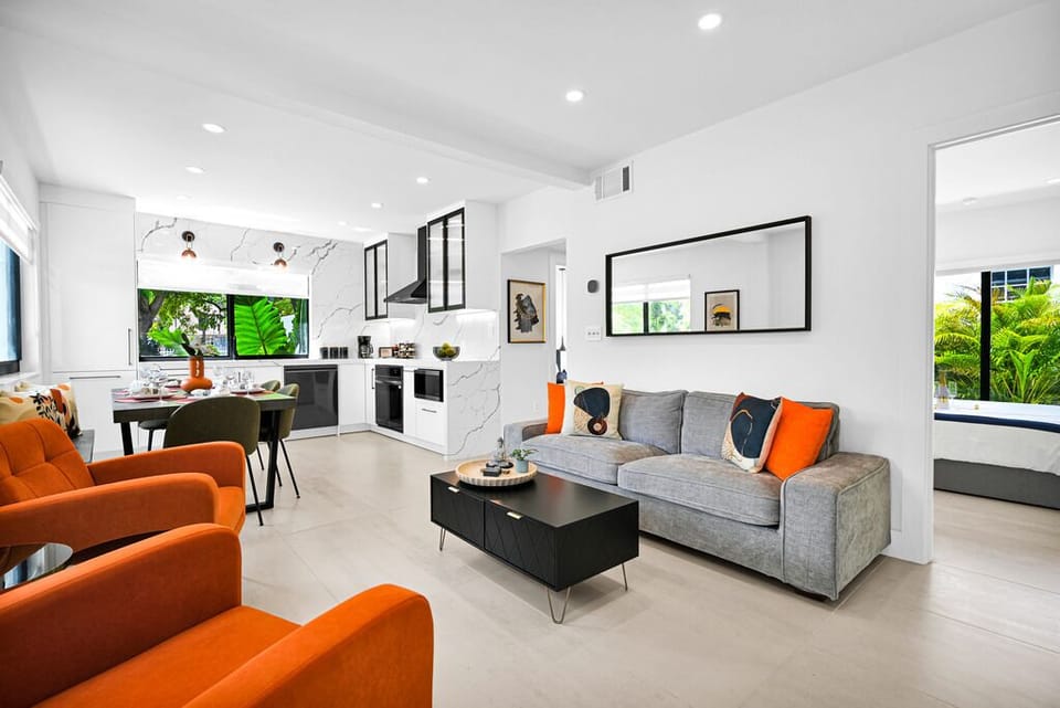 Open-concept living and kitchen space with vibrant accents and natural light.