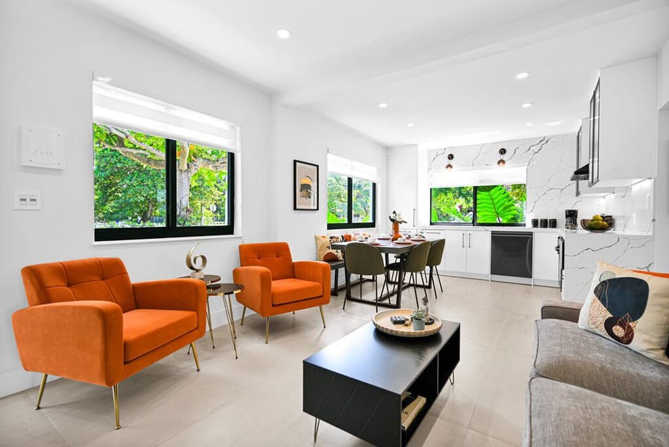 Bright open-plan living area with lush views and stylish furnishings.