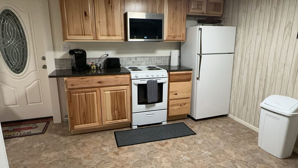 Kitchen showing private entrance door.