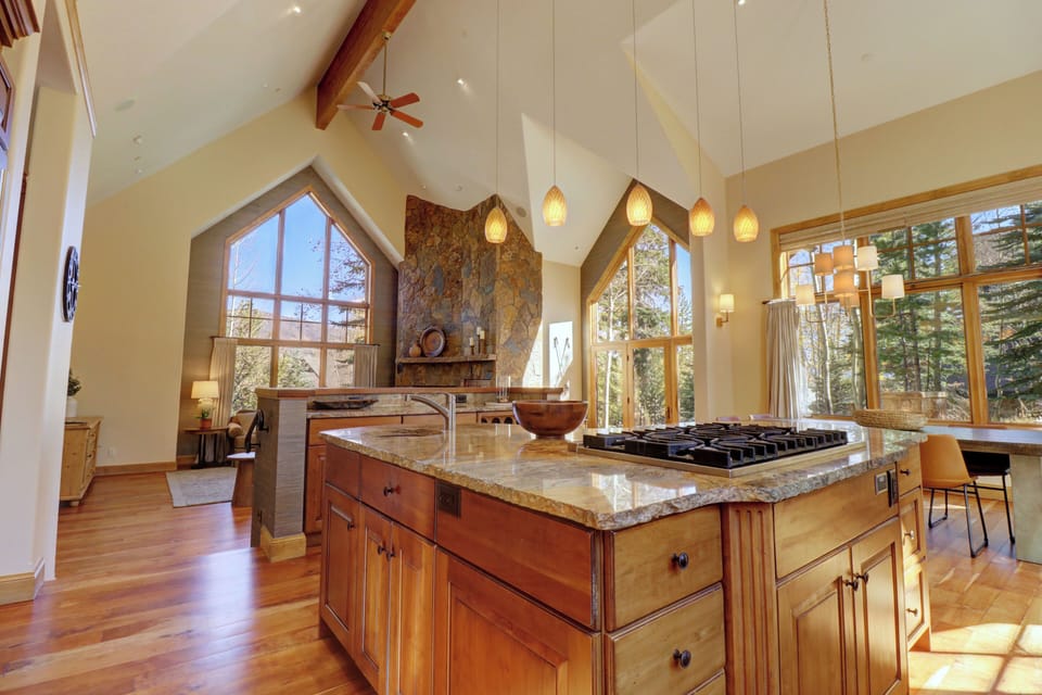 Open concept living area, kitchen looking out to living and dining rooms.