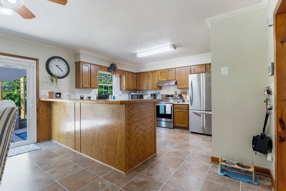 Modern kitchen with fridge and oven, ideal for cooking and entertaining.