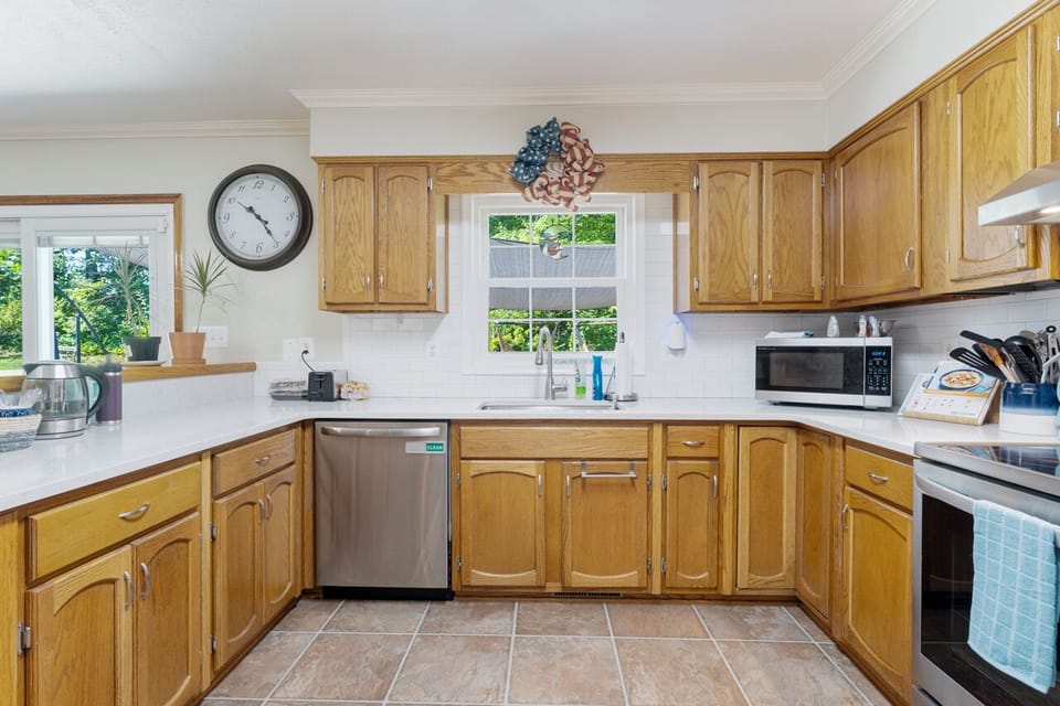 Charming kitchen with wooden cabinets, modern appliances, and generous space.