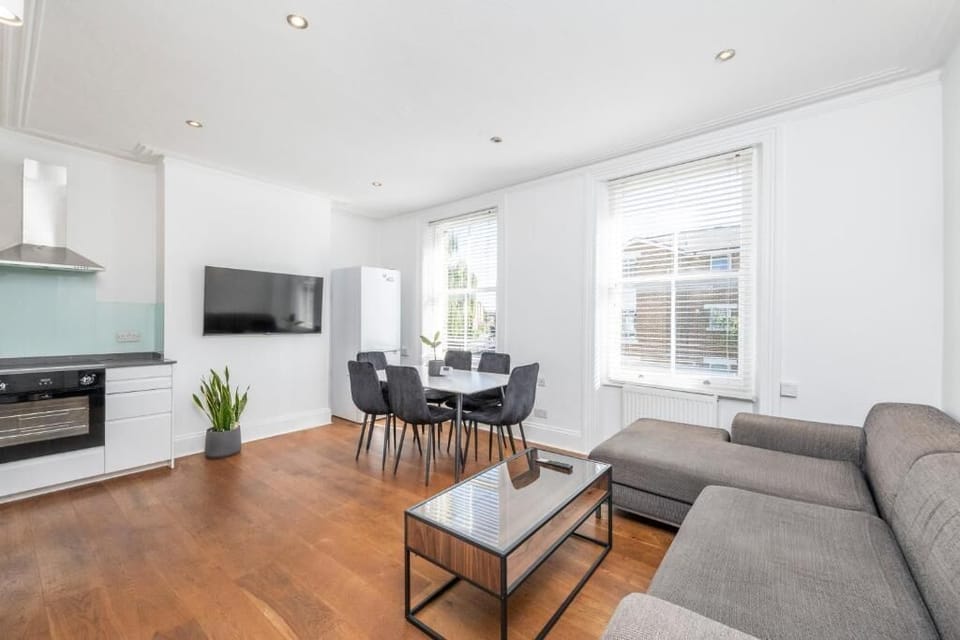 Contemporary living room with dining and TV