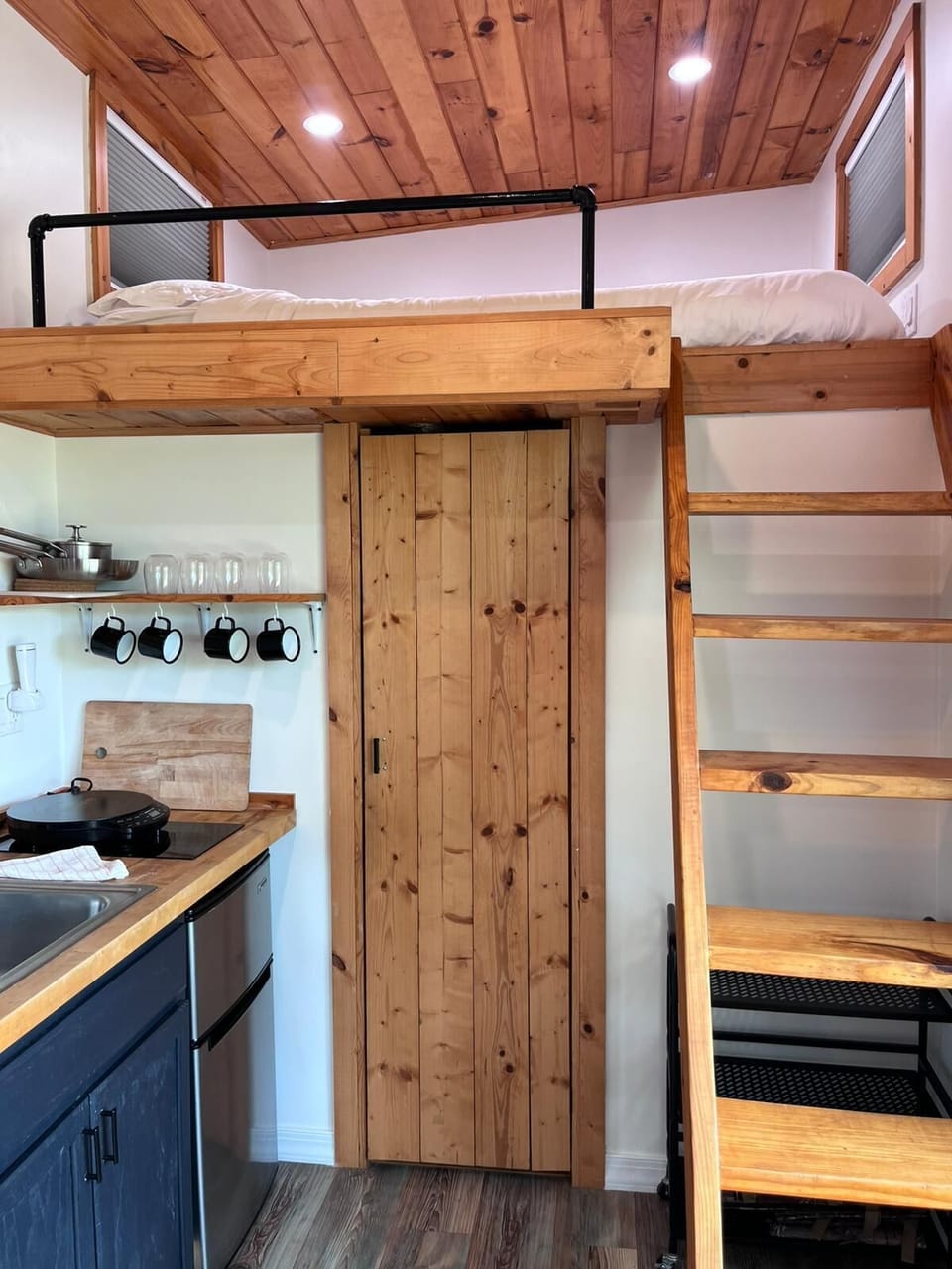 Bathroom entrance with loft bed over.