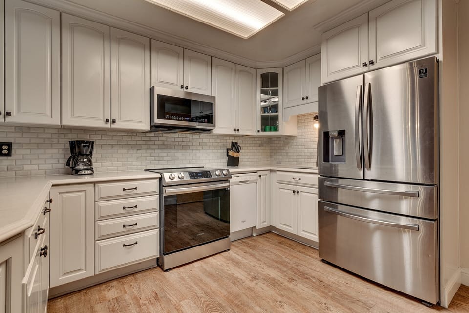 - Updated kitchen with spacious countertops and subway tile backsplash  
- Stainless steel refrigerator and modern range oven  
- Fully stocked cooking space for extended family stays