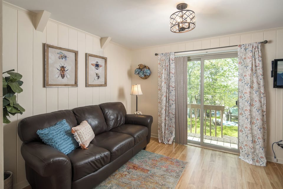 Leather sofa with deck access and garden view.