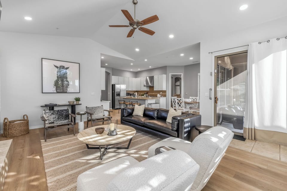 Offers leather sofa seating, accent chairs and a gas fireplace and opens to the kitchen area