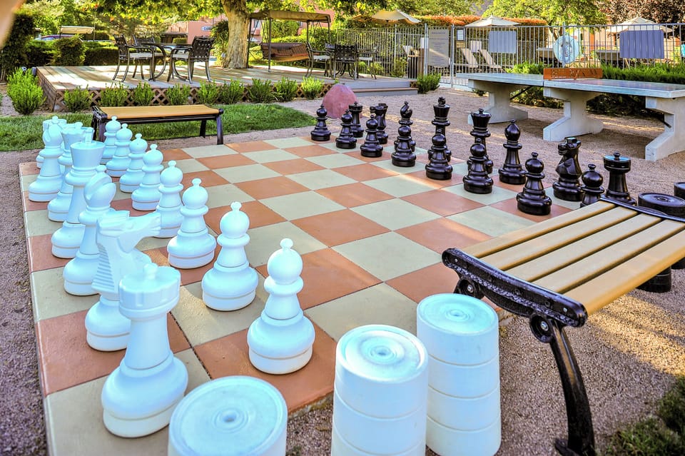 Unwind outdoors with oversized chess and sunny garden seating.