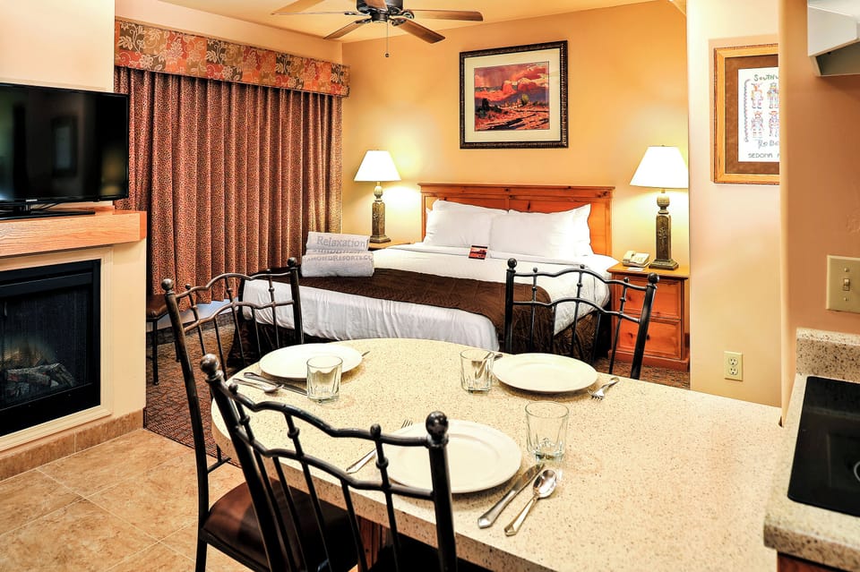 Gather for easy meals with bed and fireplace nearby.