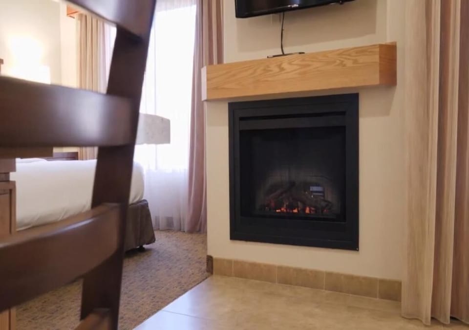 Cozy up by the glowing fireplace after a full day out.