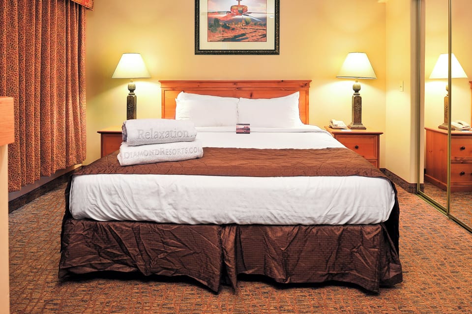 Unwind into crisp linens and warm bedside glow nightly.