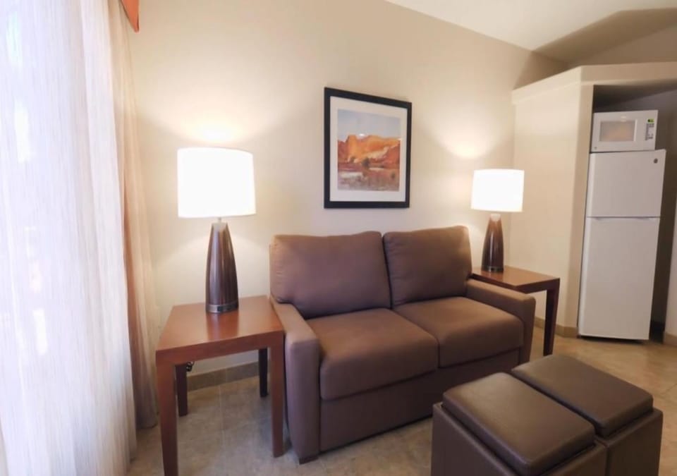 Sink into the sofa and relax under warm, cozy lighting.