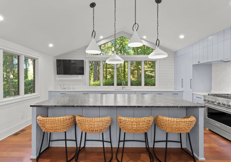 Fully stocked gourmet kitchen with integrated appliances and bar seating for 4. 