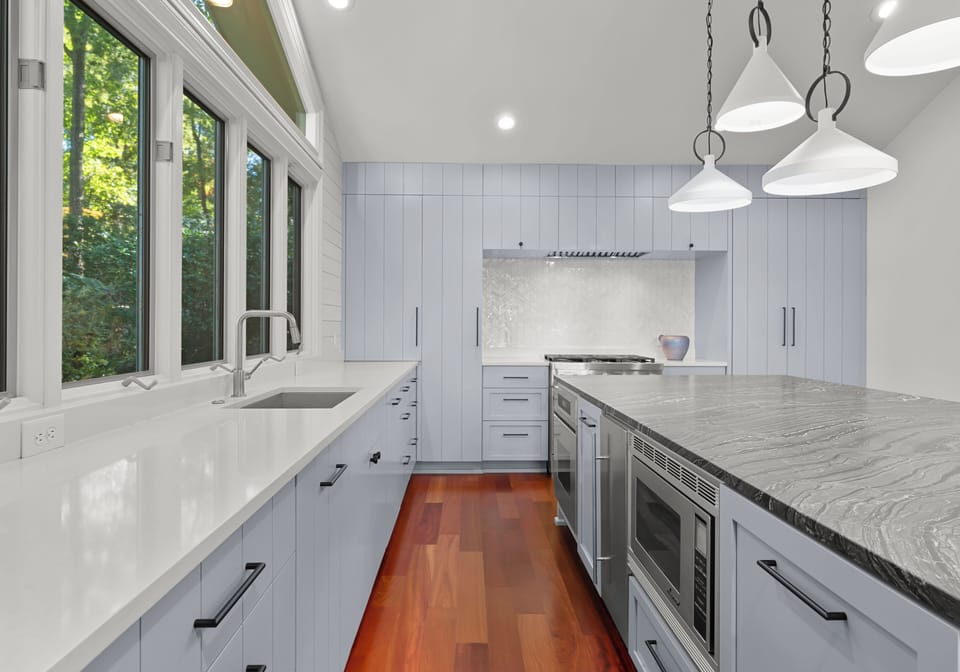 Fully stocked gourmet kitchen with integrated appliances and bar seating for 4. 