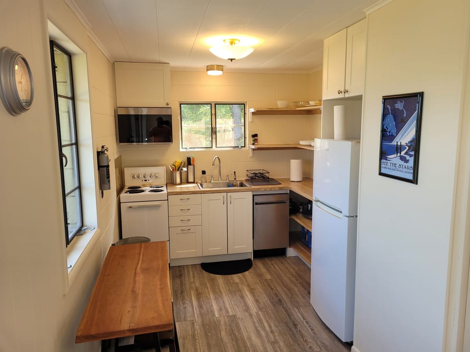 KITCHEN:  The home has a very cute and newly updated kitchen with all appliances, including a dishwasher.  Also includes a small breakfast nook with stools and a great view of Crystal Lake!