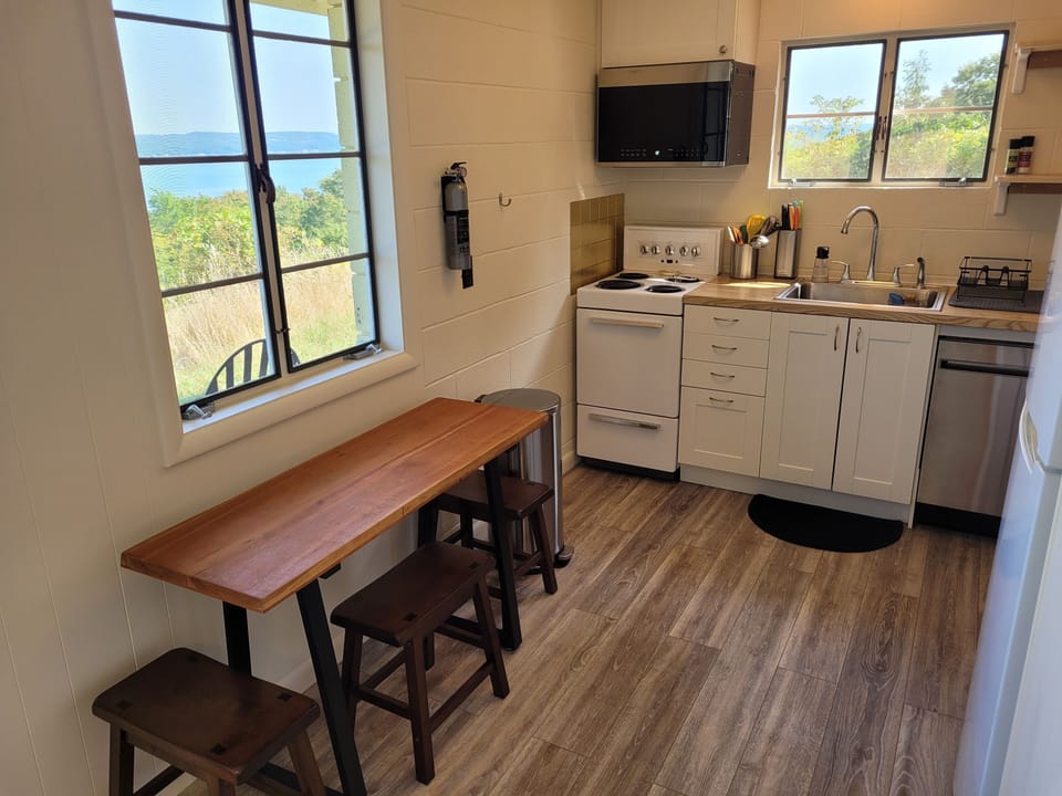 KITCHEN:  The home has a very cute and newly updated kitchen with all appliances, including a dishwasher.  Also includes a small breakfast nook with stools and a great view of Crystal Lake!