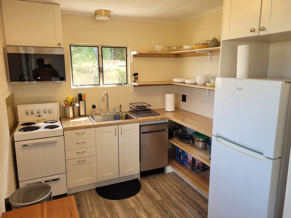 KITCHEN:  The home has a very cute and newly updated kitchen with all appliances, including a dishwasher.  Also includes a small breakfast nook with stools and a great view of Crystal Lake!