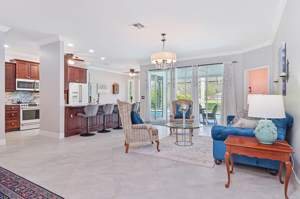 CC9251 - Living with sliding doors opening up to the screened in patio and pool area