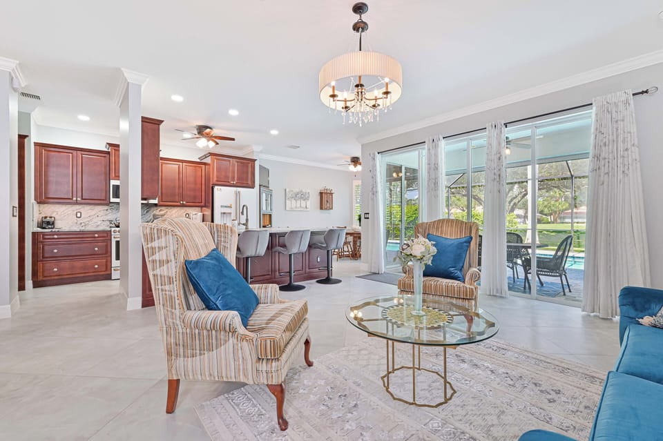 CC9251 - Living with sliding doors opening up to the screened in patio and pool area