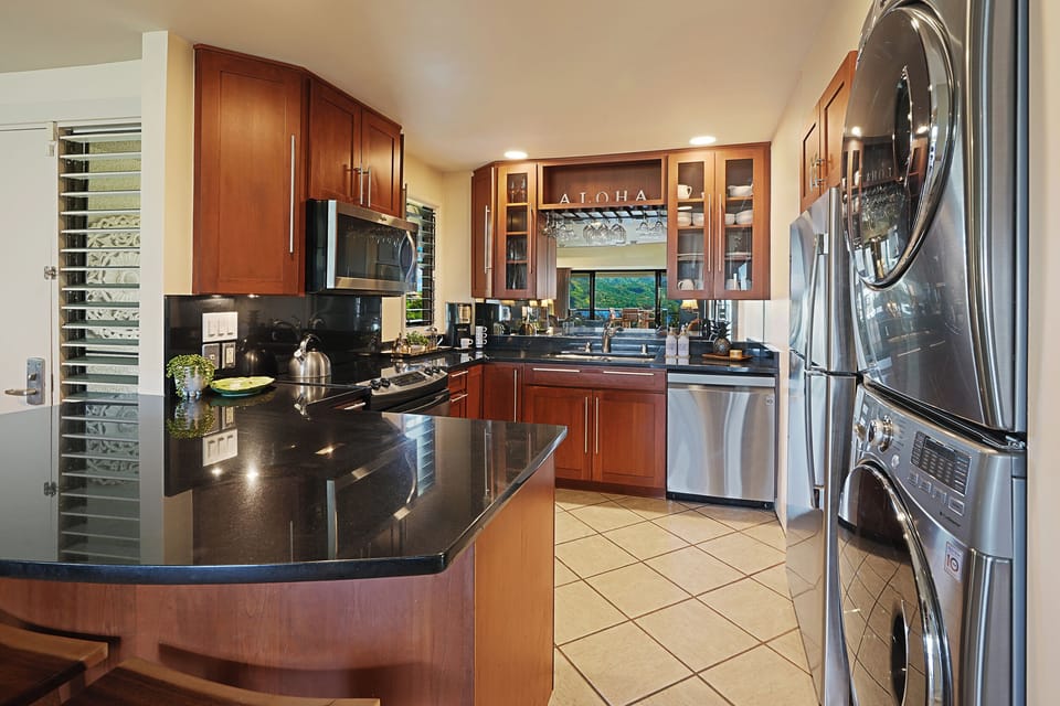 The kitchen has wide counter spaces and stainless steel appliances. – Ideal for preparing meals in style and convenience.