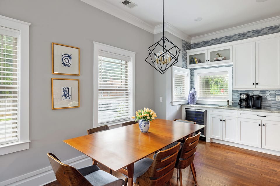 Dining table with a leaf and two additional chairs available for more seating.