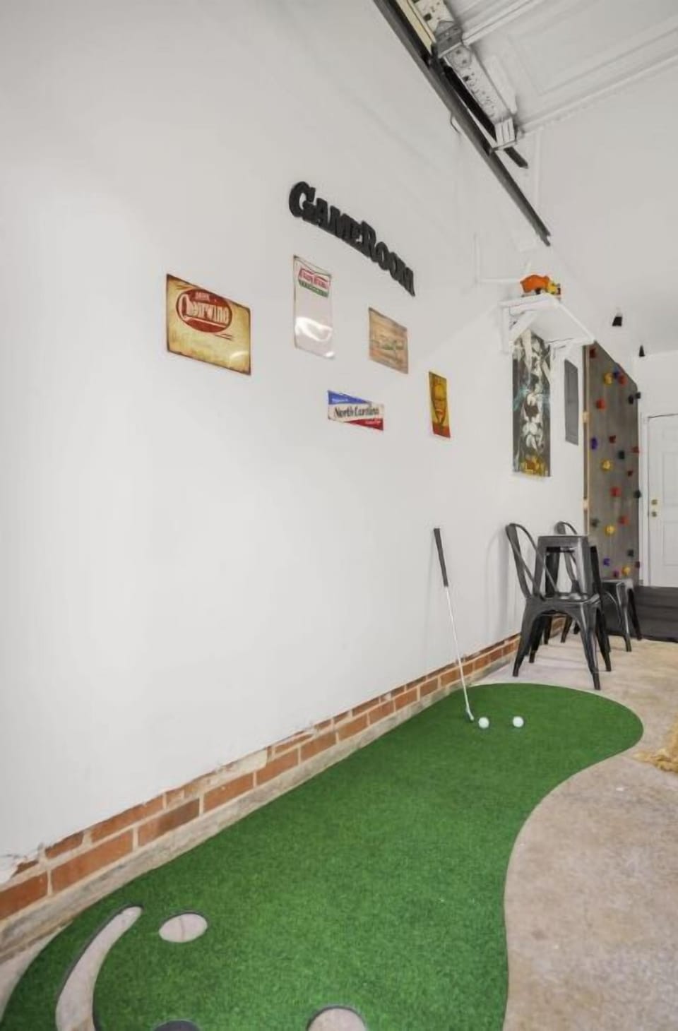 The game room with a putt-putt golf course, foosball, and a rock climbing wall. 