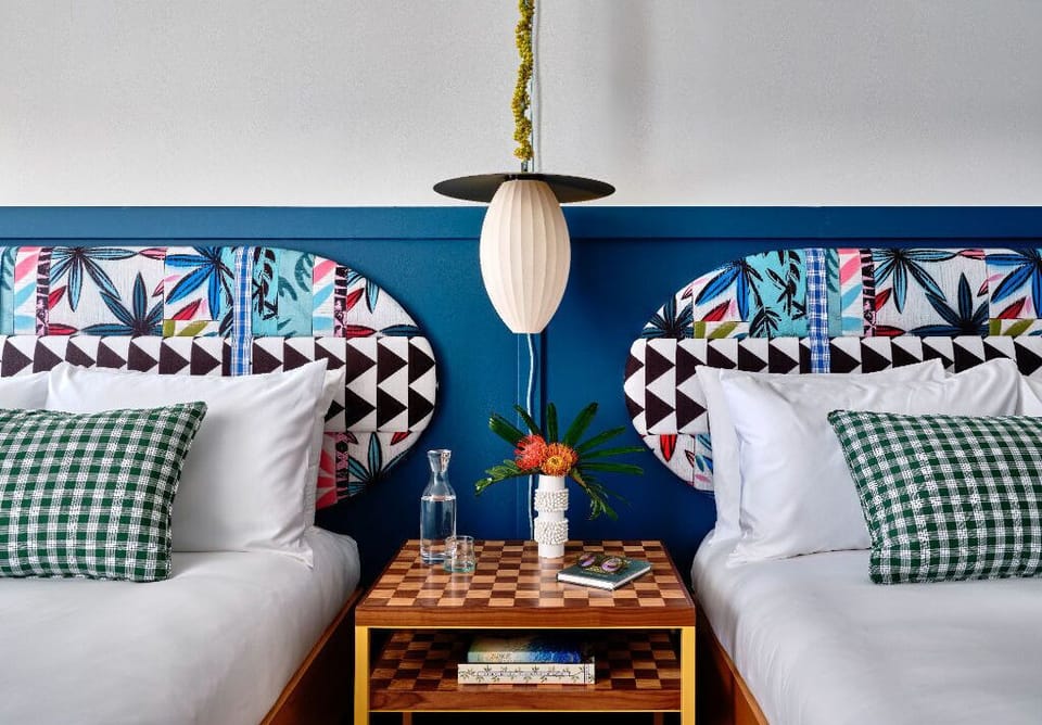 Playful patterns and bold colors bring energy to this cozy room, offering a delightful space to rest and recharge.