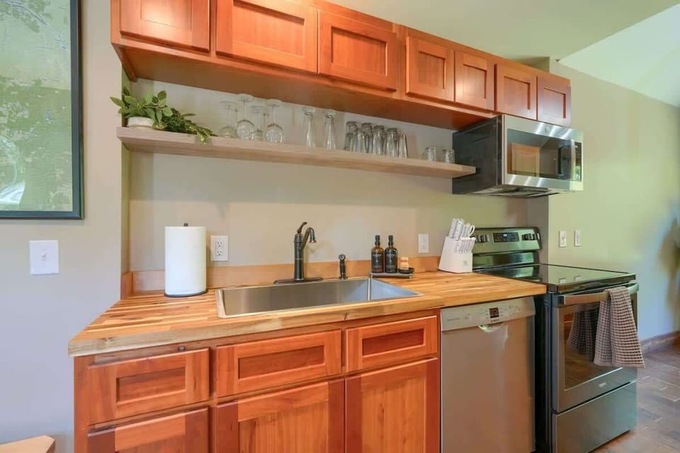 Sleek Kitchen: Prepare culinary delights in this stylish space with modern appliances and warm wood tones!