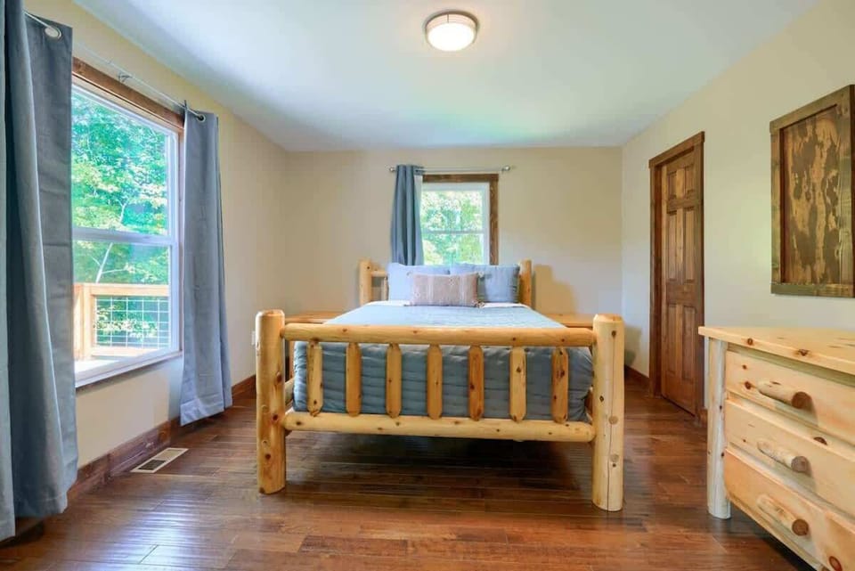 Rustic Retreat: Enjoy serene views and natural wood accents in this charming bedroom!