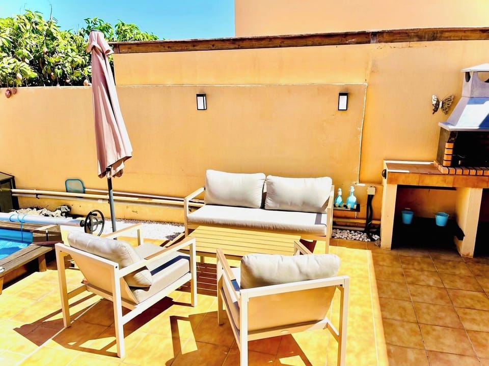 comfortable outdoor seating area beside pool