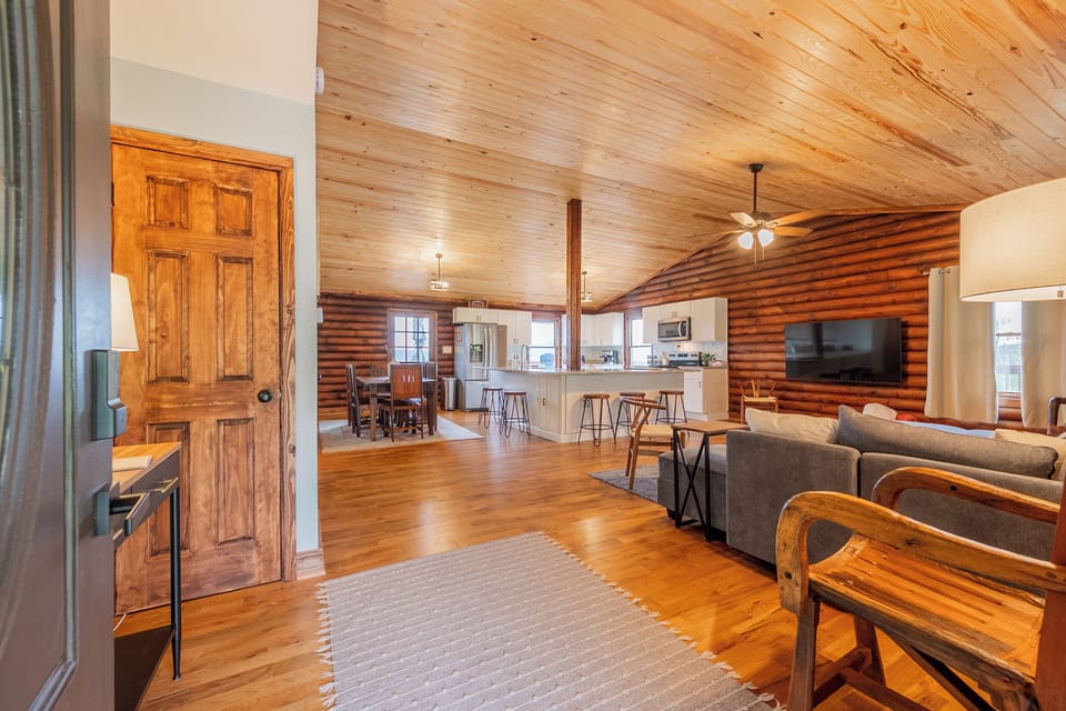 Welcome to the heart of Valley View Getaway! This spacious open-concept living area features stunning wooden ceilings and warm natural light, creating an inviting atmosphere. The comfortable living room, complete with a plush sofa, provides the perfect spot to relax and enjoy the view of the surrounding landscape. Adjacent to the living space is the modern kitchen, equipped wit...