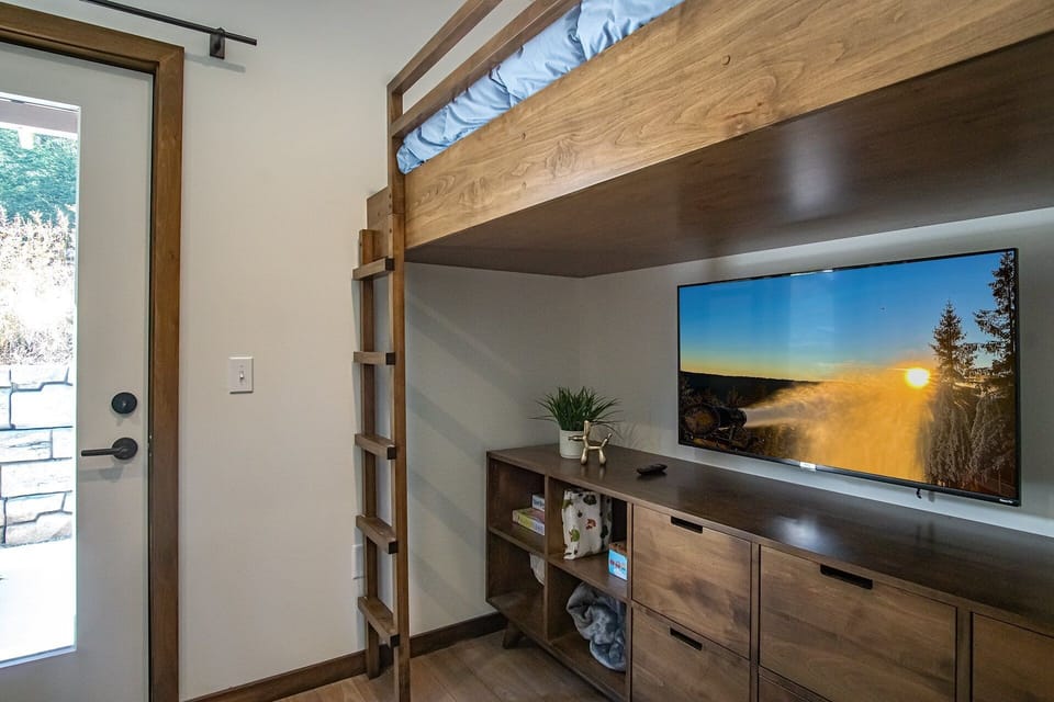 This bedroom is on the first floor and features 2 custom twin loft beds on both sides of the room.
