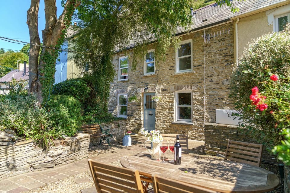 The outside of Castell Cwtch with patio table and chairs