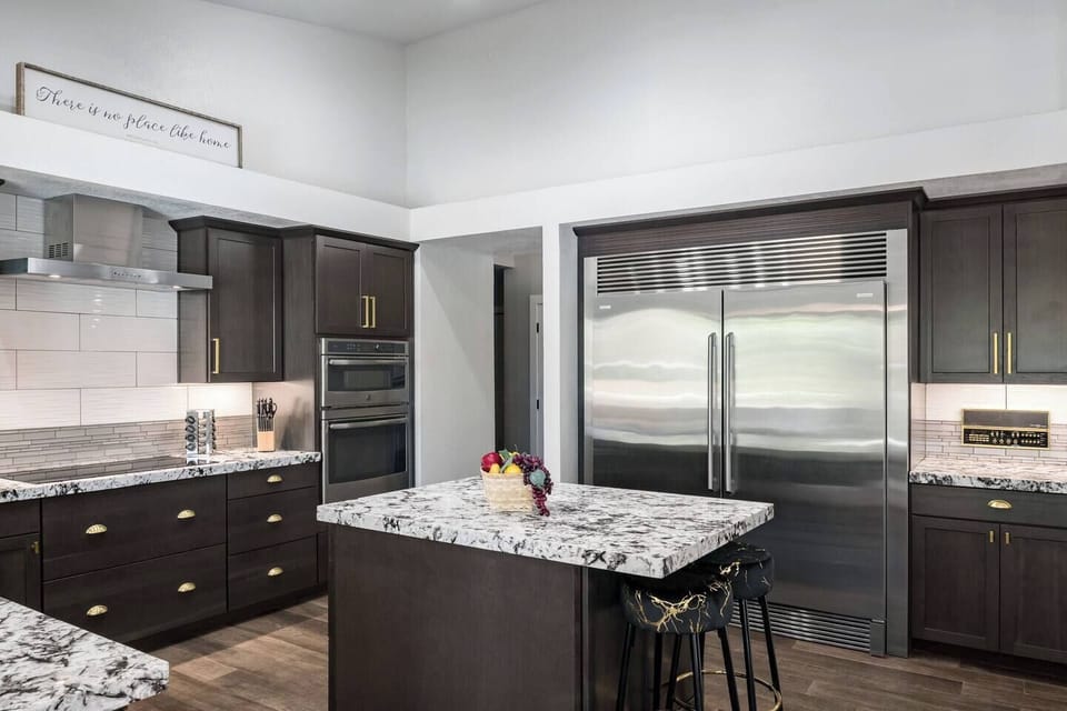 Gourmet kitchen with premium appliances, a commercial-grade fridge, and a large island — ideal for cooking, entertaining, and making memories over great food.