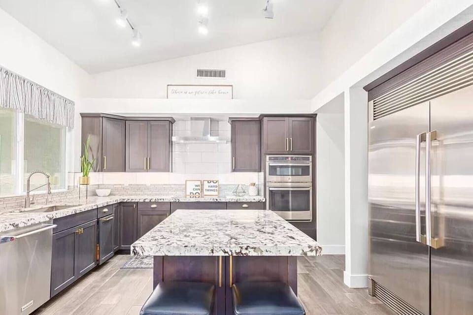 Gourmet kitchen complete with high end appliances, commercial grade refrigerator, large island for cooking and entertaining