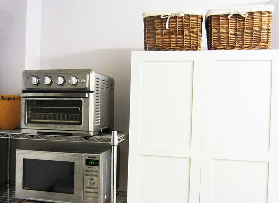 Microwave and air fyer along with other kitchen supplies.
