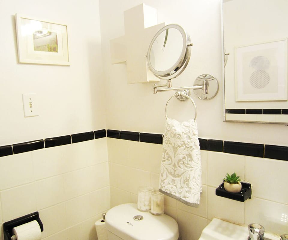 Full bathroom with tub and Aveda products.