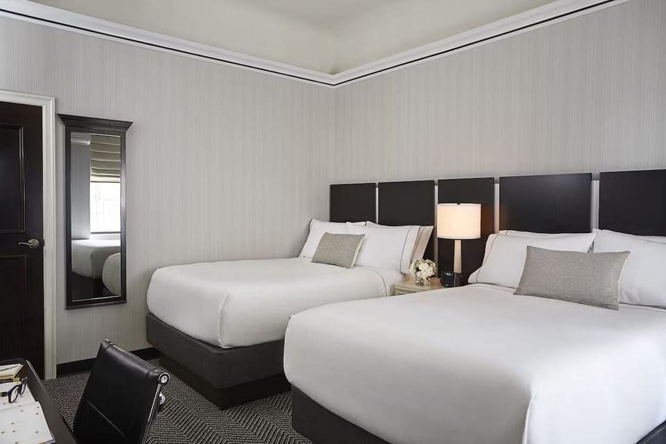 Recharge together in a spacious double-queen room, perfectly made.