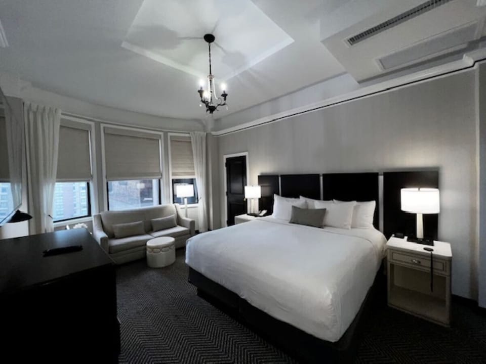 Unwind in a spacious king bedroom with cozy lounge seating.