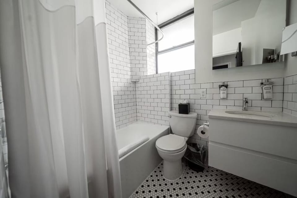 Refresh in a crisp, tile bath with bright natural light.