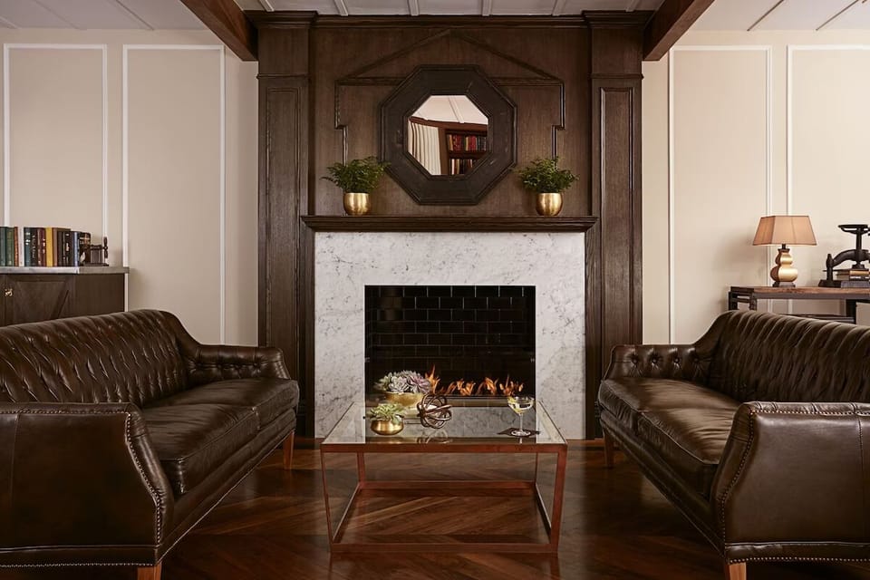 Unwind by the glowing fireplace in a refined, cozy lounge.