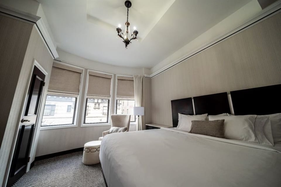 Relax beneath elegant chandelier lighting and calm, cozy décor.