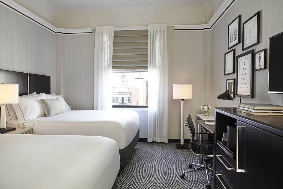 Stretch out in a bright double-queen room with cozy lighting.